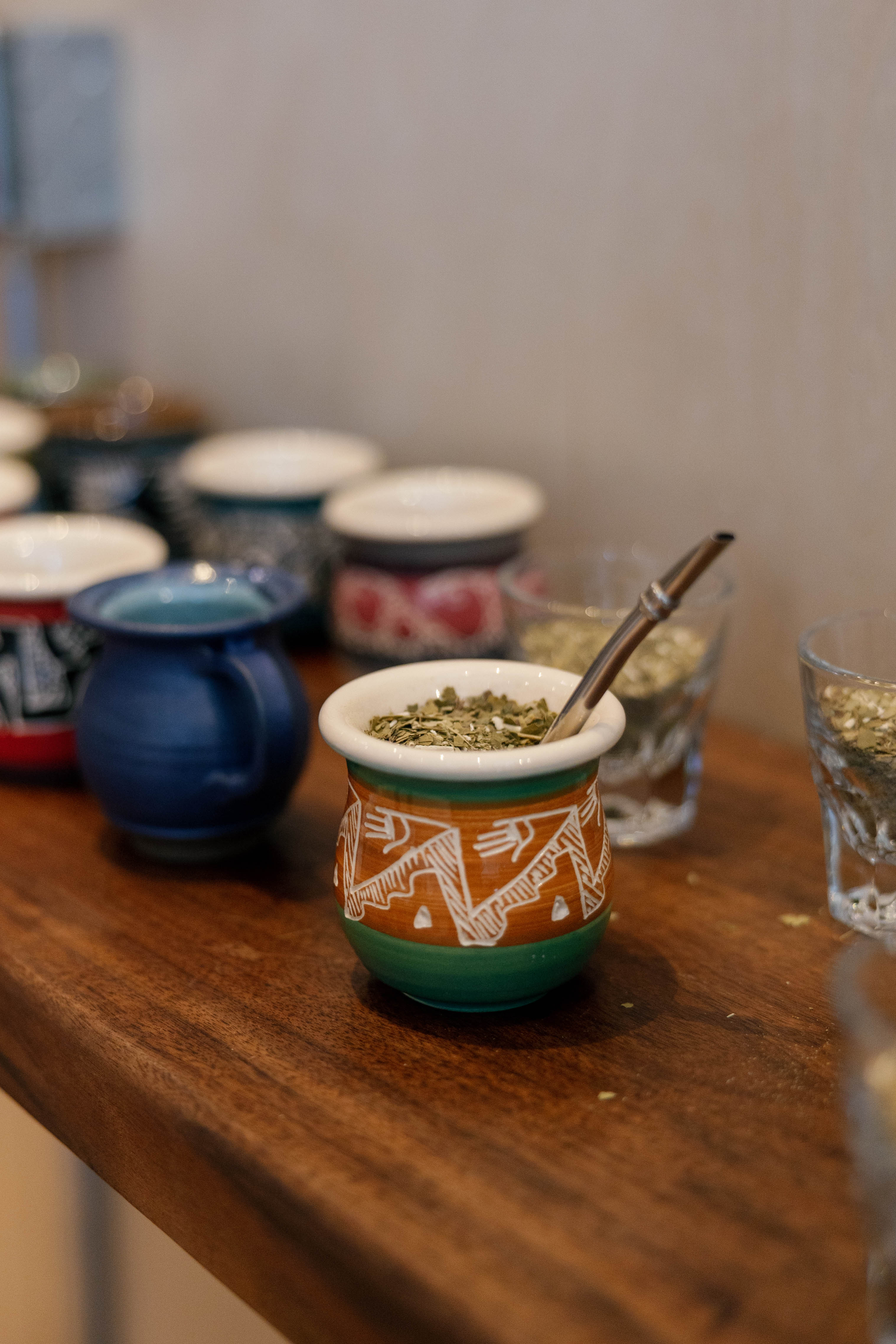 A table spread of mates filled with yerba, ready to drink.