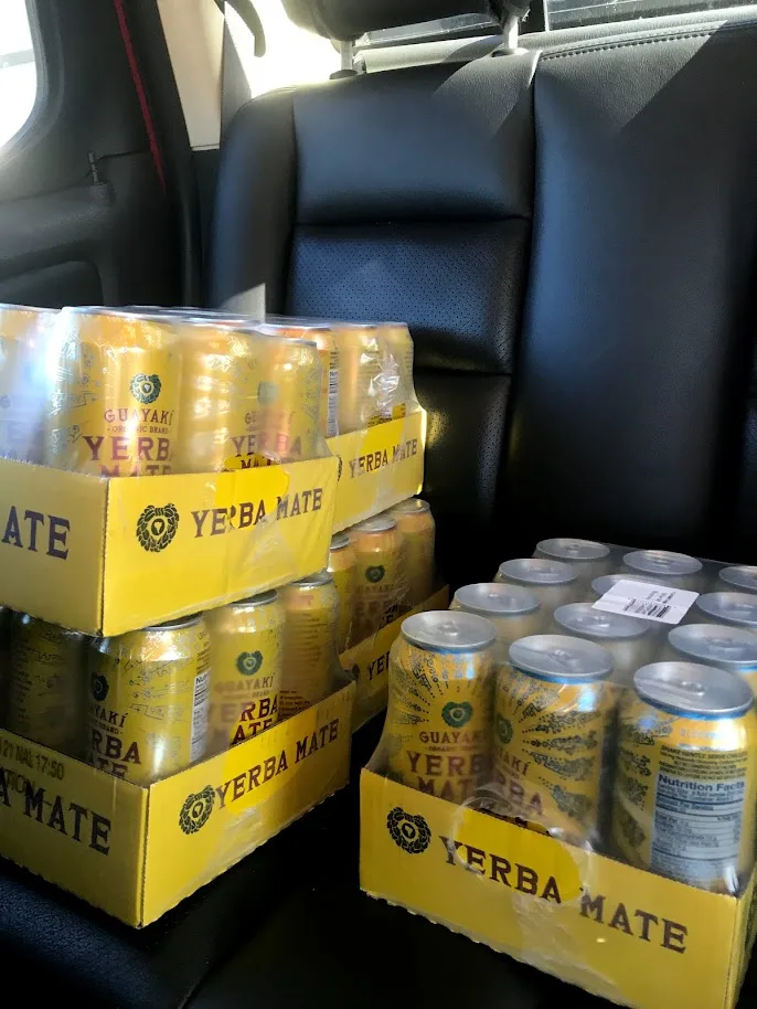 Boxes of Guayaki Yerba Mate stacked in a car on campus