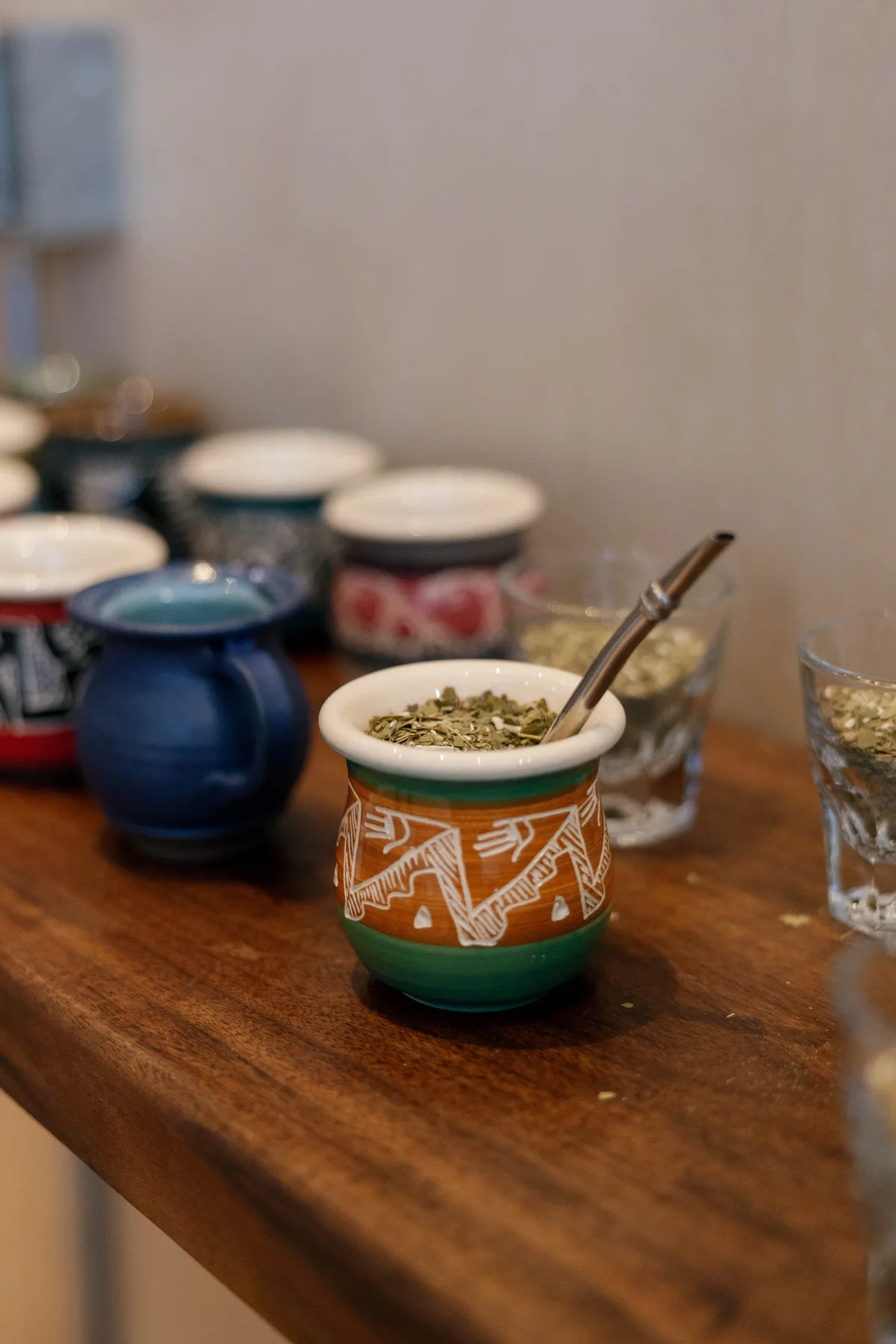 A table spread of mates filled with yerba, ready to drink.